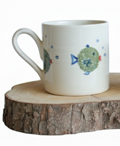 Stable Door Potter large white mug with fish designs on a wooden surface